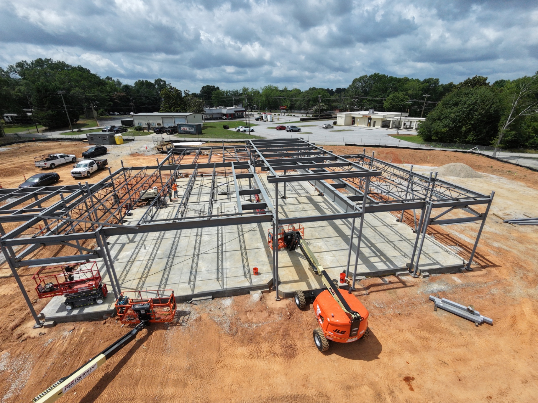 The structural frame takes shape over the poured slab as crews continue erection.